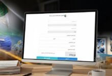 Use the provided reference image as the main visual reference. Generate an ultra-realistic landscape photograph (610x254) showing a computer or laptop screen displaying the Algerian "Espace Enseignants" (Teachers’ Space) portal, based on the referenced screenshot. Recreate the interface style, colors, and general layout from the reference image, but blur or abstract any readable text for privacy. The setting should depict a realistic teacher’s workspace: a wooden desk, papers, pen, and a cup of coffee or reading glasses nearby. Soft natural daylight, high realism, and a clean educational atmosphere. No watermark, no added text beyond what appears blurred on the screen, no visible faces.
